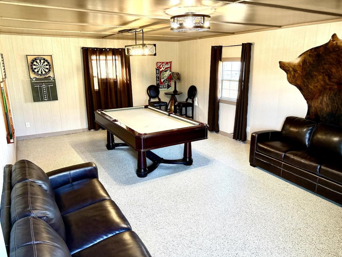 Game room with pool table, dart board and two queen size sleeper sofas with memory foam mattress. (This game room is not attached to the main home.)
